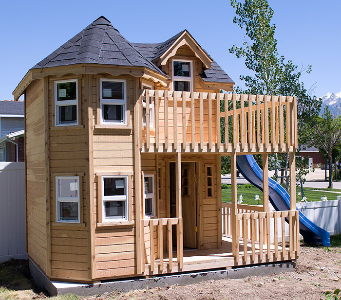 wood playhouse with deck and turret