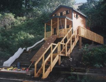 custom condo playhouse with deck and slide