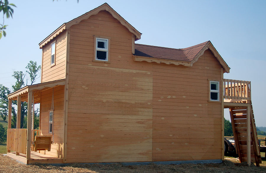 Image of backside of wood playhouse